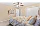 Cozy bedroom featuring neutral walls, double closet, and a ceiling fan for added comfort at 11013 Se 169Th Pl, Summerfield, FL 34491
