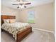 Relaxing bedroom featuring a ceiling fan and a window view to the outside at 11013 Se 169Th Pl, Summerfield, FL 34491
