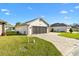 Charming single-story home with well-manicured lawn and inviting brick paver driveway at 11013 Se 169Th Pl, Summerfield, FL 34491