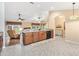 Spacious kitchen with granite counters, wood cabinets, a breakfast bar, and tile flooring at 11013 Se 169Th Pl, Summerfield, FL 34491