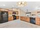 Open kitchen with tile floors, granite countertops, wood cabinets, and stainless steel appliances at 11013 Se 169Th Pl, Summerfield, FL 34491