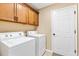 Functional laundry room with washer, dryer, and ample cabinet space for storage at 11013 Se 169Th Pl, Summerfield, FL 34491