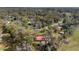 Aerial view of the home, showcasing its location among mature trees and the surrounding neighborhood at 1300 Ne 53Rd St, Ocala, FL 34479