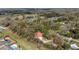Aerial view of the property showcasing mature trees, a red roof, and the surrounding landscape at 1300 Ne 53Rd St, Ocala, FL 34479