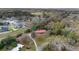 Expansive aerial view of the red-roofed home nestled among mature trees and lush greenery in a countryside neighborhood at 1300 Ne 53Rd St, Ocala, FL 34479