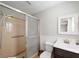 Bathroom featuring a tub shower with sliding glass door, single sink vanity, and framed mirror at 1300 Ne 53Rd St, Ocala, FL 34479