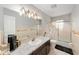 Bathroom featuring a large mirror with vanity lighting, a shower/tub combination, and a granite countertop at 1300 Ne 53Rd St, Ocala, FL 34479