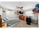 Well-lit bedroom with a ceiling fan, two windows, a wooden dresser, and plush carpet at 1300 Ne 53Rd St, Ocala, FL 34479