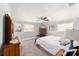 Bright bedroom featuring neutral walls, carpet, ceiling fan, and two windows providing natural light at 1300 Ne 53Rd St, Ocala, FL 34479