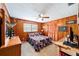 Spacious bedroom with wood paneled walls, ceiling fan, and a window bringing in natural light at 1300 Ne 53Rd St, Ocala, FL 34479