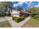 Side view of a brick home, features an attached garage and well-maintained landscaping at 1300 Ne 53Rd St, Ocala, FL 34479