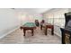 Spacious game room featuring a pool table, foosball table, and an arcade game at 1300 Ne 53Rd St, Ocala, FL 34479