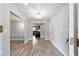 Hallway showing light wood floors and a bright, open transition into the living room at 1300 Ne 53Rd St, Ocala, FL 34479