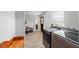 A bright laundry room with a wooden bench, updated washer and dryer, and a window providing natural light at 1300 Ne 53Rd St, Ocala, FL 34479