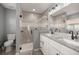 Bathroom with a double sink vanity, granite countertop, walk-in shower and updated fixtures at 13458 Sw 113Th Pl, Dunnellon, FL 34432