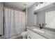 Bathroom features a shower with a patterned curtain, and a granite countertop at 13458 Sw 113Th Pl, Dunnellon, FL 34432