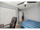 Bedroom with ceiling fan, closet, and view into living space at 13458 Sw 113Th Pl, Dunnellon, FL 34432