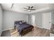 Bedroom featuring a trey ceiling, ceiling fan, wood-look floors, and a view to an ensuite bathroom at 13458 Sw 113Th Pl, Dunnellon, FL 34432