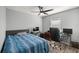 Bedroom with ceiling fan, a bed, a window and desk with multiple monitors at 13458 Sw 113Th Pl, Dunnellon, FL 34432