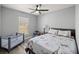 Bedroom with a ceiling fan, playpen, and a window providing natural light at 13458 Sw 113Th Pl, Dunnellon, FL 34432