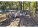 Cozy outdoor fire pit area with Adirondack chairs perfect for entertaining in a tranquil wooded setting at 13458 Sw 113Th Pl, Dunnellon, FL 34432