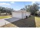 Attached two-car garage with a wide driveway, offering ample parking space and convenient access to the home at 13458 Sw 113Th Pl, Dunnellon, FL 34432