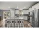Modern kitchen with white cabinets, granite countertops, stainless steel appliances, and island with seating at 13458 Sw 113Th Pl, Dunnellon, FL 34432