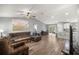 Open-concept living room with vaulted ceiling, wood-look floors, and a sliding glass door leading to the outdoors at 13458 Sw 113Th Pl, Dunnellon, FL 34432