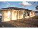 Rear of the house featuring sliding glass doors and several windows for ample natural light at 13700 Sw 48Th Ct, Ocala, FL 34473
