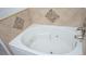 Corner bathtub with jets and decorative tile at 13700 Sw 48Th Ct, Ocala, FL 34473