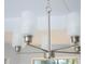 Contemporary four-light chandelier with brushed nickel finish and frosted shades at 13700 Sw 48Th Ct, Ocala, FL 34473