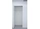 A clean, empty closet space with white walls, a wire shelf and an open door at 13700 Sw 48Th Ct, Ocala, FL 34473