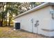 View of the home's exterior featuring the AC unit, electrical box, and well-maintained siding at 13700 Sw 48Th Ct, Ocala, FL 34473
