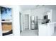 Modern white kitchen featuring stainless steel appliances, a walk-in pantry, and ample counter space at 13700 Sw 48Th Ct, Ocala, FL 34473