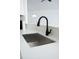 Kitchen features a stainless steel sink with black faucet and white countertops at 13700 Sw 48Th Ct, Ocala, FL 34473