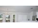Bright living room features large windows, modern light fixtures, and stainless steel appliances at 13700 Sw 48Th Ct, Ocala, FL 34473