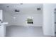Open-concept living room with a ceiling fan, light grey floors, and neutral paint at 13700 Sw 48Th Ct, Ocala, FL 34473