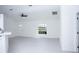 Bright living room with a ceiling fan, window and pristine white walls and floors at 13700 Sw 48Th Ct, Ocala, FL 34473