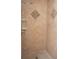 Shower features built-in shower caddy and decorative tile accent at 13700 Sw 48Th Ct, Ocala, FL 34473