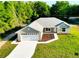 Charming single-story home with a well-manicured lawn and an attached two-car garage at 14 Bay Terrace Pass, Ocklawaha, FL 32179