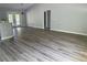 Spacious living room with luxury vinyl plank flooring, neutral paint, and ample natural light at 14 Bay Terrace Pass, Ocklawaha, FL 32179