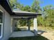 Relaxing covered patio with a ceiling fan, perfect for outdoor entertaining and enjoying the backyard at 14 Bay Terrace Pass, Ocklawaha, FL 32179