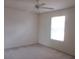 Cozy bedroom with carpet flooring, a ceiling fan and a bright window at 15756 Sw 37Th Cir, Ocala, FL 34473