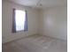 Bright bedroom featuring neutral carpet, a ceiling fan, and a sunlit window at 15756 Sw 37Th Cir, Ocala, FL 34473