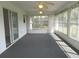 Bright sunroom with carpet flooring, ceiling fans, and multiple windows overlooking the backyard at 15756 Sw 37Th Cir, Ocala, FL 34473