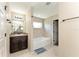 Bathroom featuring dark wood vanity, large mirror, and a tub at 159 Water Trak, Ocala, FL 34472