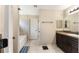 Well-lit bathroom featuring a dark wood vanity, neutral tile, and a tub at 159 Water Trak, Ocala, FL 34472