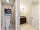 Bathroom with toilet, dark wood vanity, mirror, and tiled floors at 159 Water Trak, Ocala, FL 34472