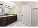 Bathroom with a dark wood vanity, large mirror, and a tiled floor at 159 Water Trak, Ocala, FL 34472
