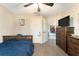 Bedroom with wood furniture, ceiling fan and neutral colored walls at 159 Water Trak, Ocala, FL 34472